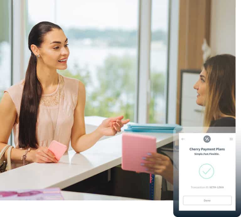 Receptionist Holding Book & Talking with Female Patient | Parlour at the Village in Salado, TX