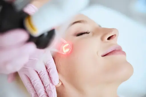 Female receiving Laser Skin Treatment with a device at Parlour at the Village in Salado, TX